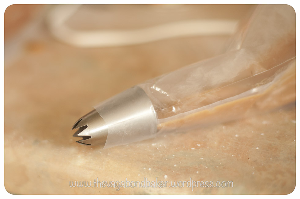 fill a piping bag with caramel then insert into another piping bag fitted with a wide nozzle