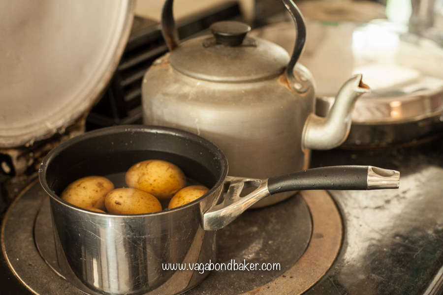 Boil the cleaned but unpeeled potatoes in salted water